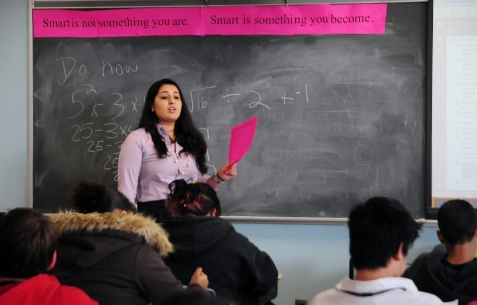 Motivational slogans surround every corner of the classroom, often printed on bright pink paper like this one, “Smart is not something you are. Smart is something you become.”