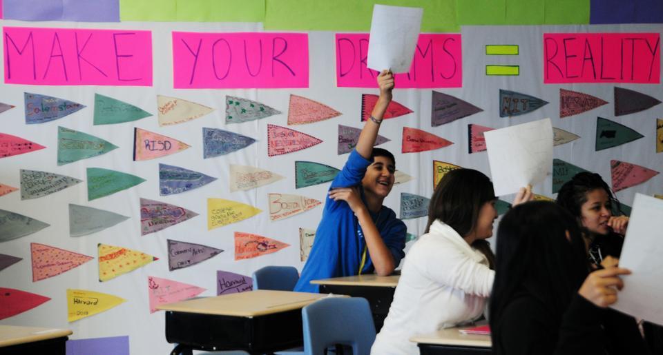Students eagerly raise their reflection sheets and share the goals they have set for themselves. The flags in the back serve as daily reminders of their dreams; a few wants to attend Harvard.