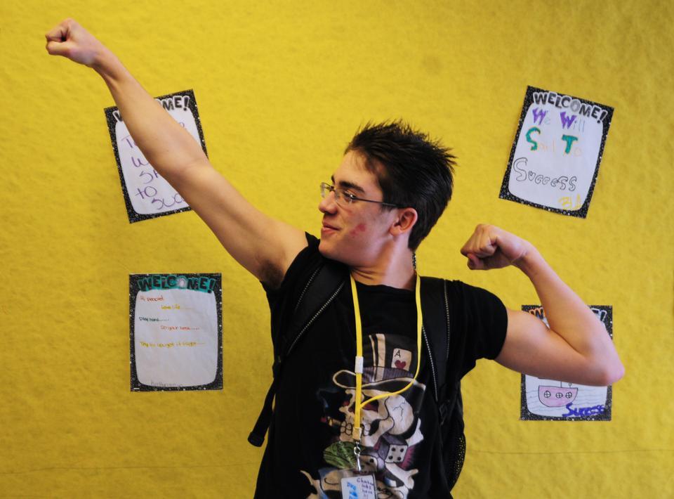 A student shows off his muscles and his love for his math teacher, Ms. Dandiya.