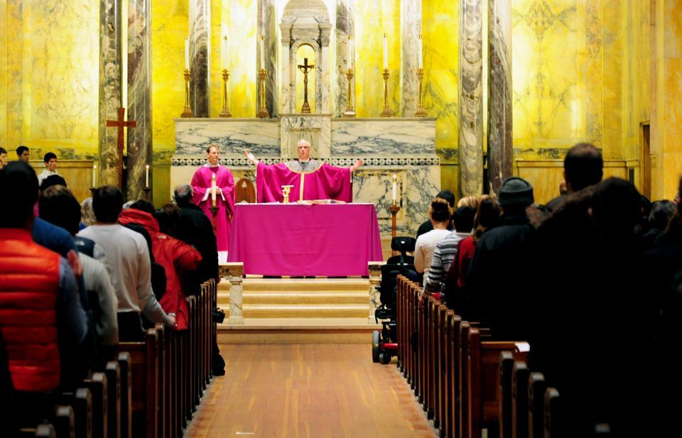 Rev. William F. Murphy leads a prayer during Ash Wednesday Mass at St. Paul's Parish.