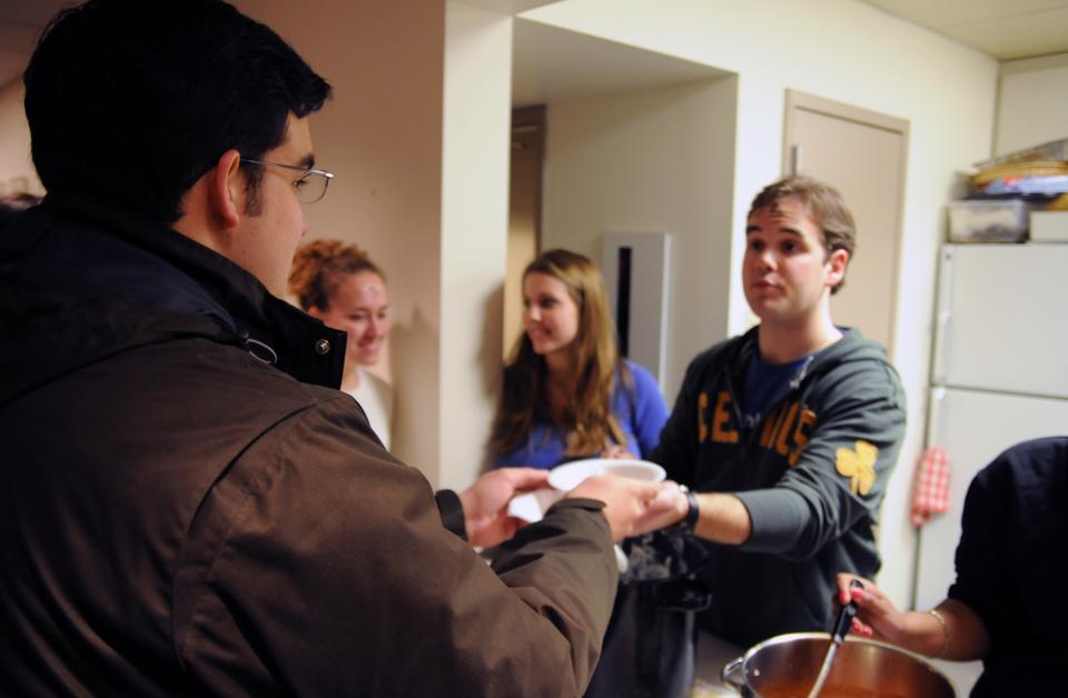 G. Andrew Conway '11 serves students dinner following Ash Wednesday mass at St. Paul's Catholic Church.