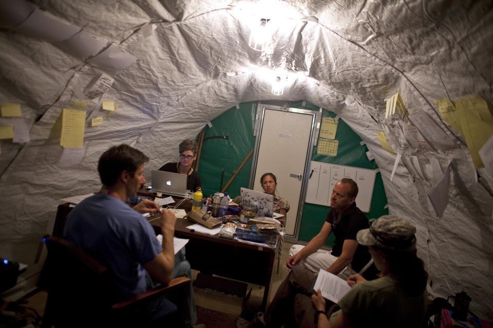 A field hospital in Fond Parisien, Haiti, was started less than a week after the earthquake hit on Jan. 12. Meeting inside a makeshift office are doctors from around the country, including (from left) Michael VanRooyen (Harvard), Hilarie Cranmer (Harvard), Jennifer Chan (Northwestern University), Christian Theodosis (University of Chicago), and Emille Calvello (Johns Hopkins).


(CORRECTION: An earlier caption for this Feb. 19 photograph incorrectly stated the affiliation of Jennifer Chan as the University of Chicago. In fact, she is affiliated with Northwestern University. The caption has been edited to reflect the error.)