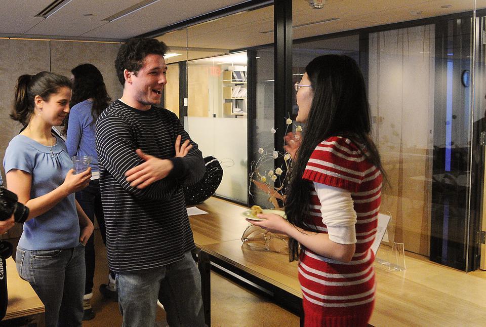 Teaching fellows discuss student projects at the project fair for "From Quarks to Consciousness: What is Life," a General Education class taught by Andrew Berry, Melissa Franklin, and Logan S. McCarty.