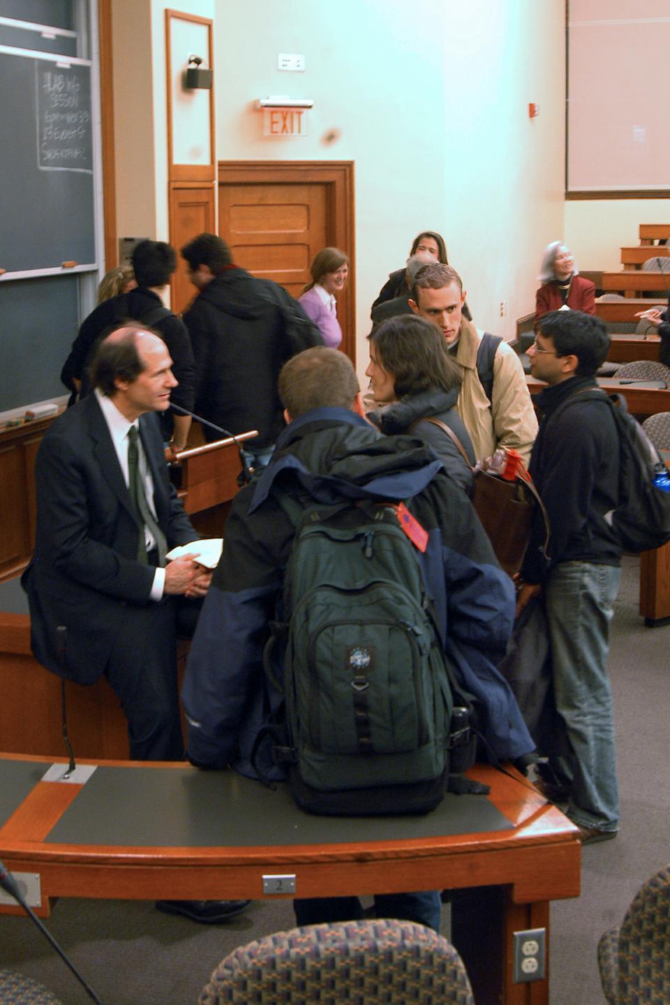 Harvard Law School Professor Cass Sunstein talks with students and faculty after his lecture at Harvard Law School yesterday night. Sunstein described ways the federal government has recently been using behavioral analysis, humanizing cost-benefit analysis, and trying to create an open government.