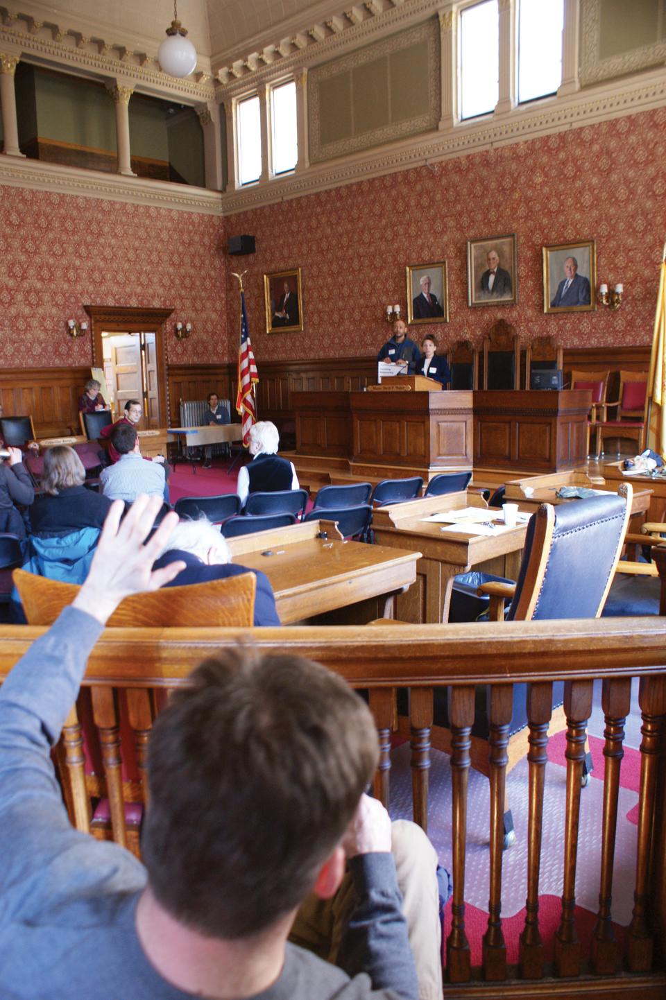 A concerned citizen asks a question at the Cambridge Climate Congress at City Hall on Saturday, March 6, 2010.