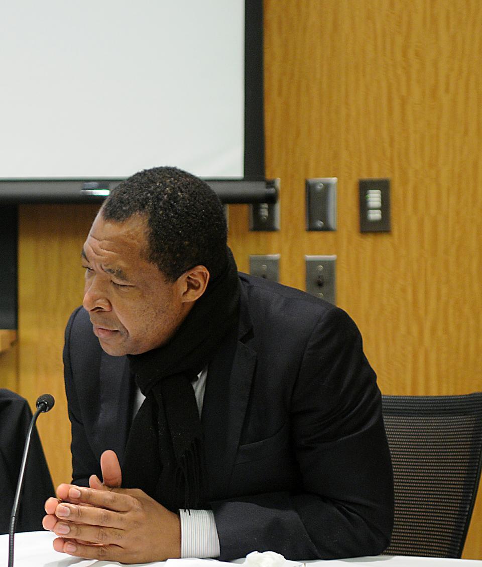 Okwui Enwezor speaking about African photography being used in different contexts at the Tsai Auditorium at CGIS south