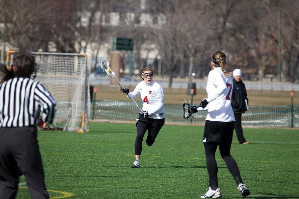 Co-captain Sara Flood, shown here in earlier action, scored one goal and drew four controls as the Harvard women’s lacrosse team defeated No. 15 New Hampshire, 10-9, in double overtime. 