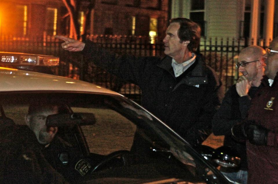 Dean of Freshmen Thomas A. Dingman ’67 speaks with Harvard University Police Department officers during River Run yesterday, when some freshmen celebrated the night despite threats of disciplinary action.