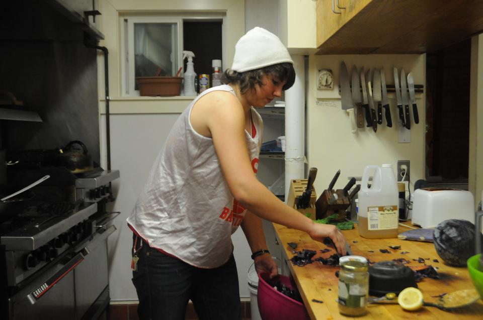 An undergraduate student cooks dinner at the Dudley Co-op in this December 2009 Crimson file photo. 