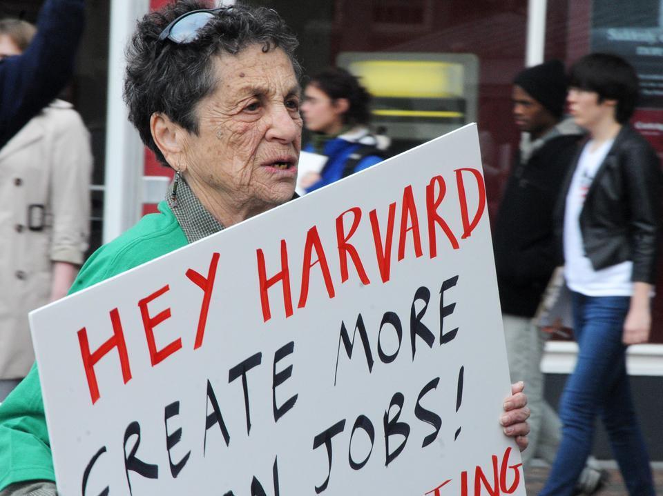 Members of the Student Labor Action Movement and Harvard employees rally outside of the Holyoke Center yesterday encouraging the University to stop employee layoffs. 