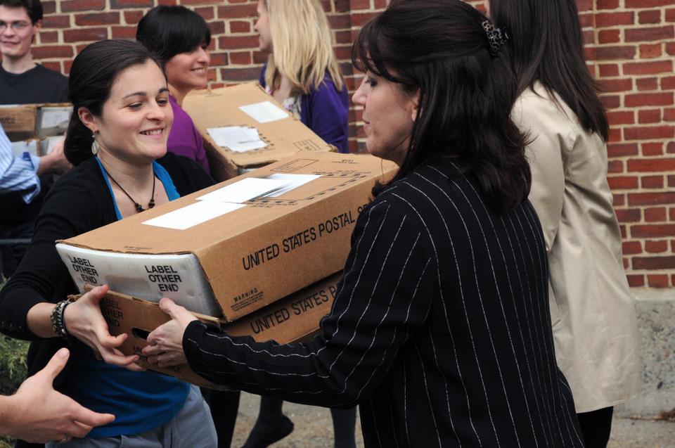 Admissions Office staff members form an assembly line to load the newly-sealed letters onto the USPS truck that will deliver the hard-copy admissions decisions to this year's 30,000 applicants. 
