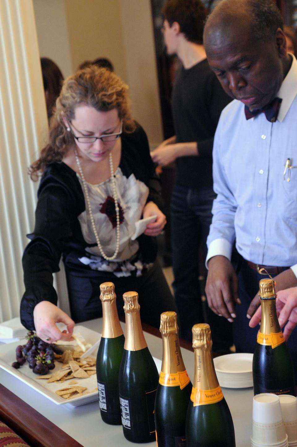 Senior admissions officer David L. Evans and his colleagues enjoy champagne, cheese, and crackers as they celebrate the send-off of the decisions on which they have deliberated for the past three months. 