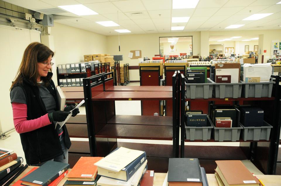 A Depository staff member works on sorting books to be sent out to Harvard's various libraries. 