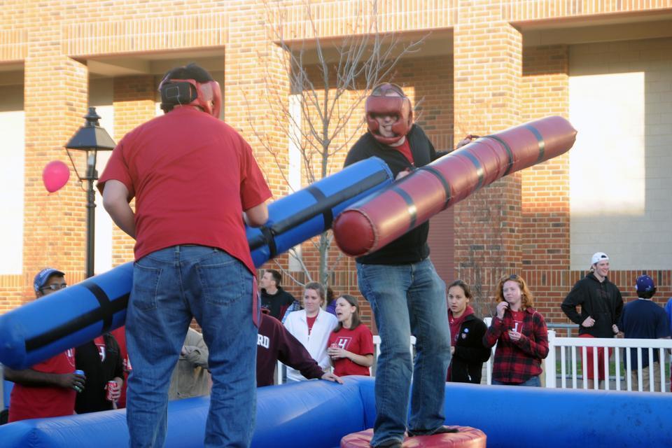 Students participate in “inflatable jousting” at the Undergraduate Council-sponsored tailgate for the Harvard-Duke men’s lacrosse game last Friday.
