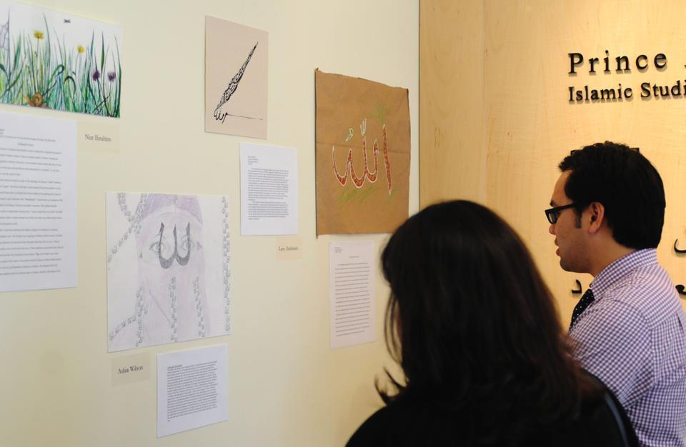 Students in Culture and Belief 12, "For the Love of God and His Prophet: Religion, Literature, and the Arts in Muslim Cultures," showcase their artwork representing a variety of calligraphic depictions of the word “Allah” at a special reception yesterday. 