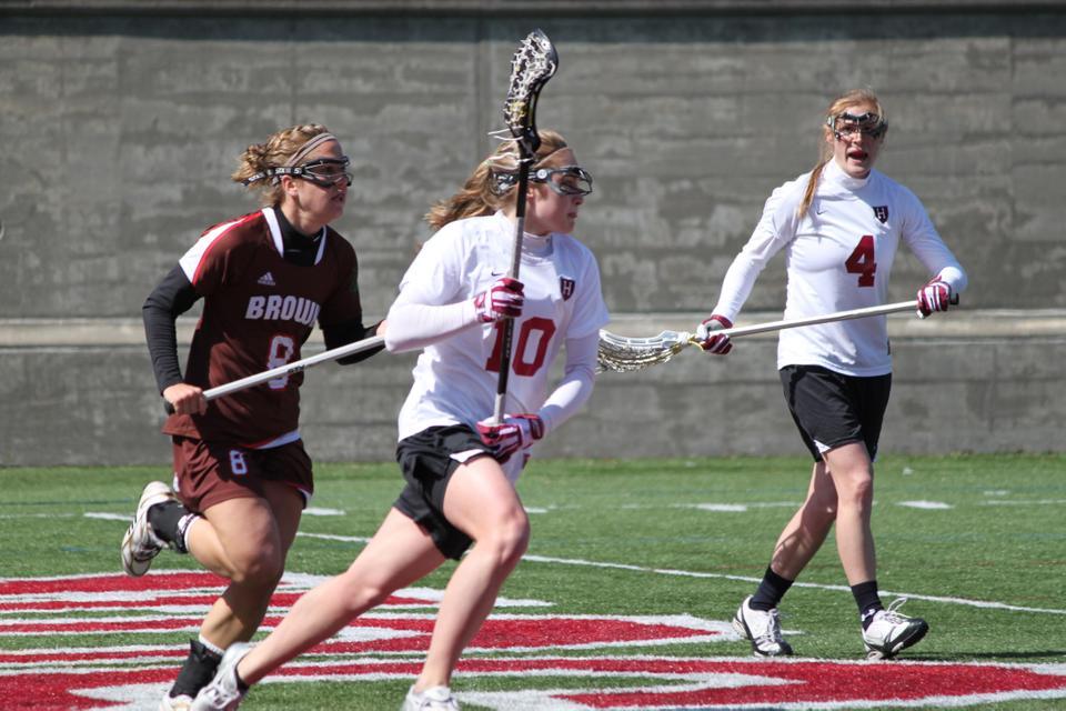 Freshman Micaela Cyr, shown here in earlier action, led the team in draw controls against Virginia last night. The Crimson built up an early lead but a late first half run put the Cavaliers ahead and they never looked back. Harvard will look to rebound off this loss against Holy Cross next week. 