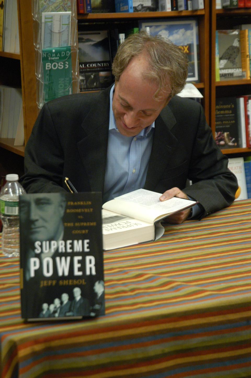 Jeff Shesol, author of "Supreme Power: Franklin Delano Roosevelt vs. The Supreme Court," holds a book signing yesterday evening at the Harvard Bookstore