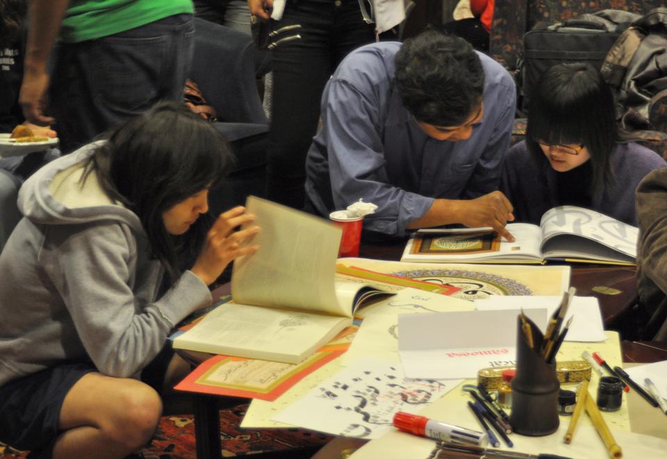 Students peruse books about Islamic culture at the “Meet the Muslims” study break yesterday evening at the Adams House Upper Common Room, as part of Islam Awareness Week.