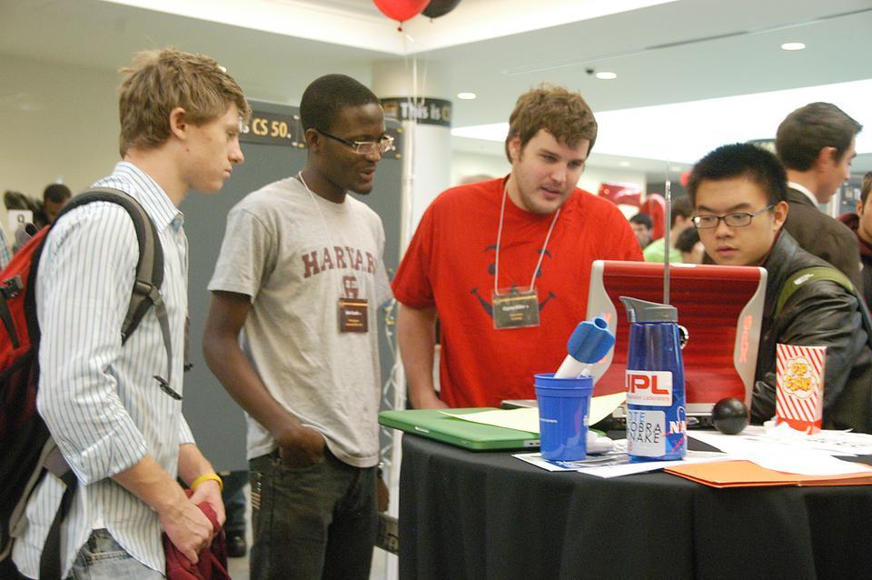 CS50 students, pictured above during the CS50 project fair last semester, will soon be allowed the alternative of taking the course SAT/UNSAT. 