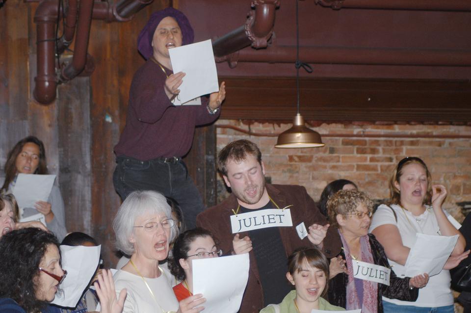 Fans recreate the balcony scene from Romeo and Juliet en masse at John Harvard's Brew House on Saturday. The group reading was part of a celebration of Shakespeare's birthday. All events were moved indoors due to inclement weather that resulted in the cancellation of a parade in the Bard's honor.