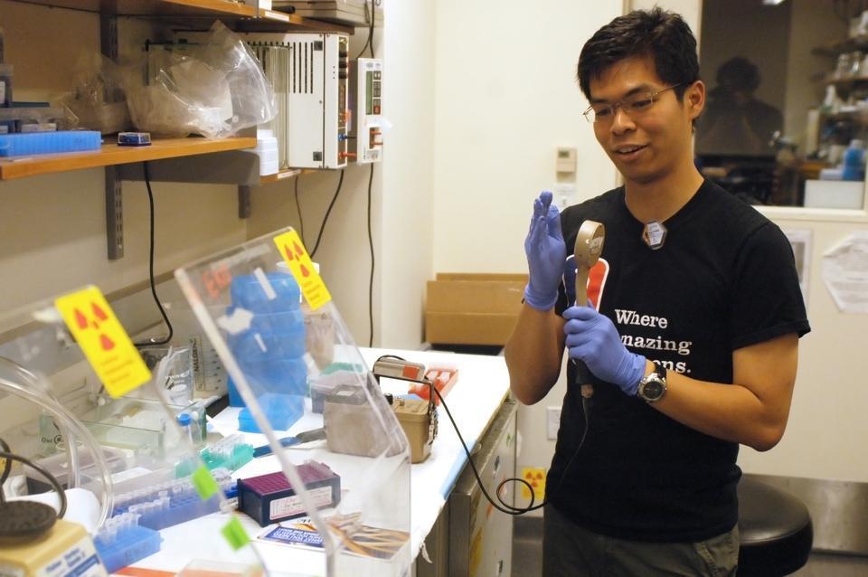 Cher Heang ("Shawn") Low '11 tests himself for radioactivity before leaving the radioactive "hot bench" in his lab. Low has already finished his research thesis.