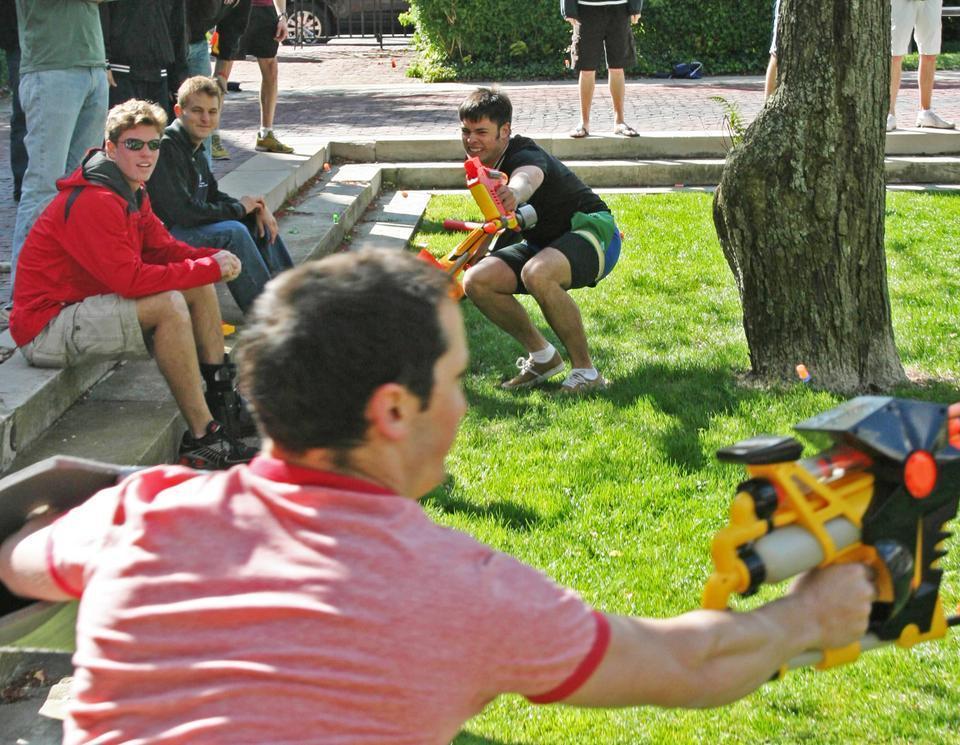 As fallen assassins look on, Adam Lathram '10 of team "F12" attempts to snipe Alexander Klein '11 of team "Kiss Kiss Bang Bang".