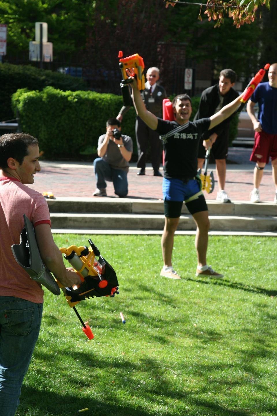 Adam M. Lathram '10 of team "F12" celebrates his victory over Alexander Klein '11 of team "Kiss Kiss Bang Bang" during the last battle of Quincy Assassins yesterday. Team "F12" came out on top in the end due to a well-placed shot by Elizabeth Balaconis '10.