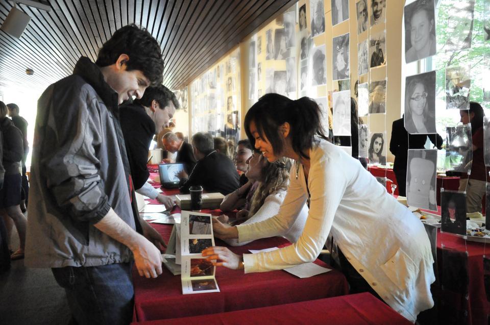 Judith E. Fan ‘10 shows Daniel M. Bear ‘10 a “photographic poem” she completed in one of her art classes during a celebration of art-making called "Art-Making=Risk-Taking" in Boylston Hall yesterday. 