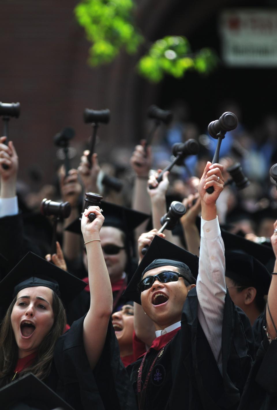 Students from the Harvard Law School Class of 2010, gavels in hand, celebrate their graduation during the morning exercises of Commencement.