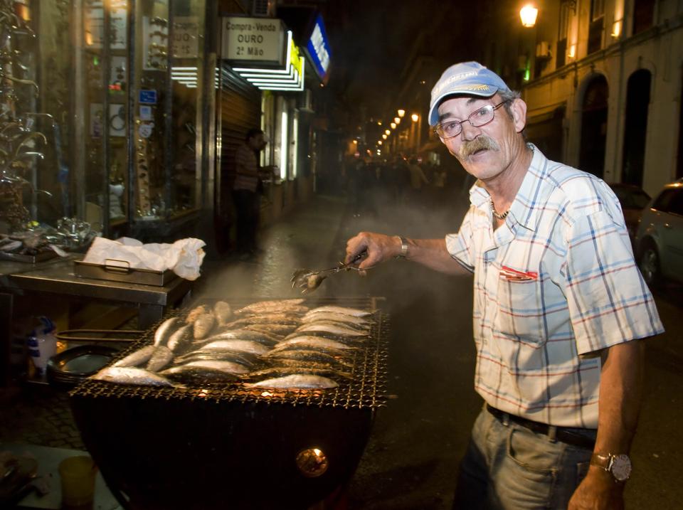 A man prepares grilled sardines, or "sardinhas assadas", the traditional food of Santos that is often
consumed right on the street.