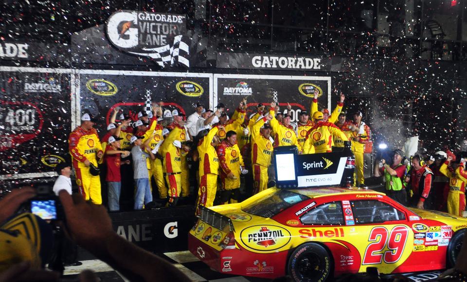  Kevin Harvick and his pit crew celebrate with confetti and champagne in Victory Lane after winning the Coke Zero 400.