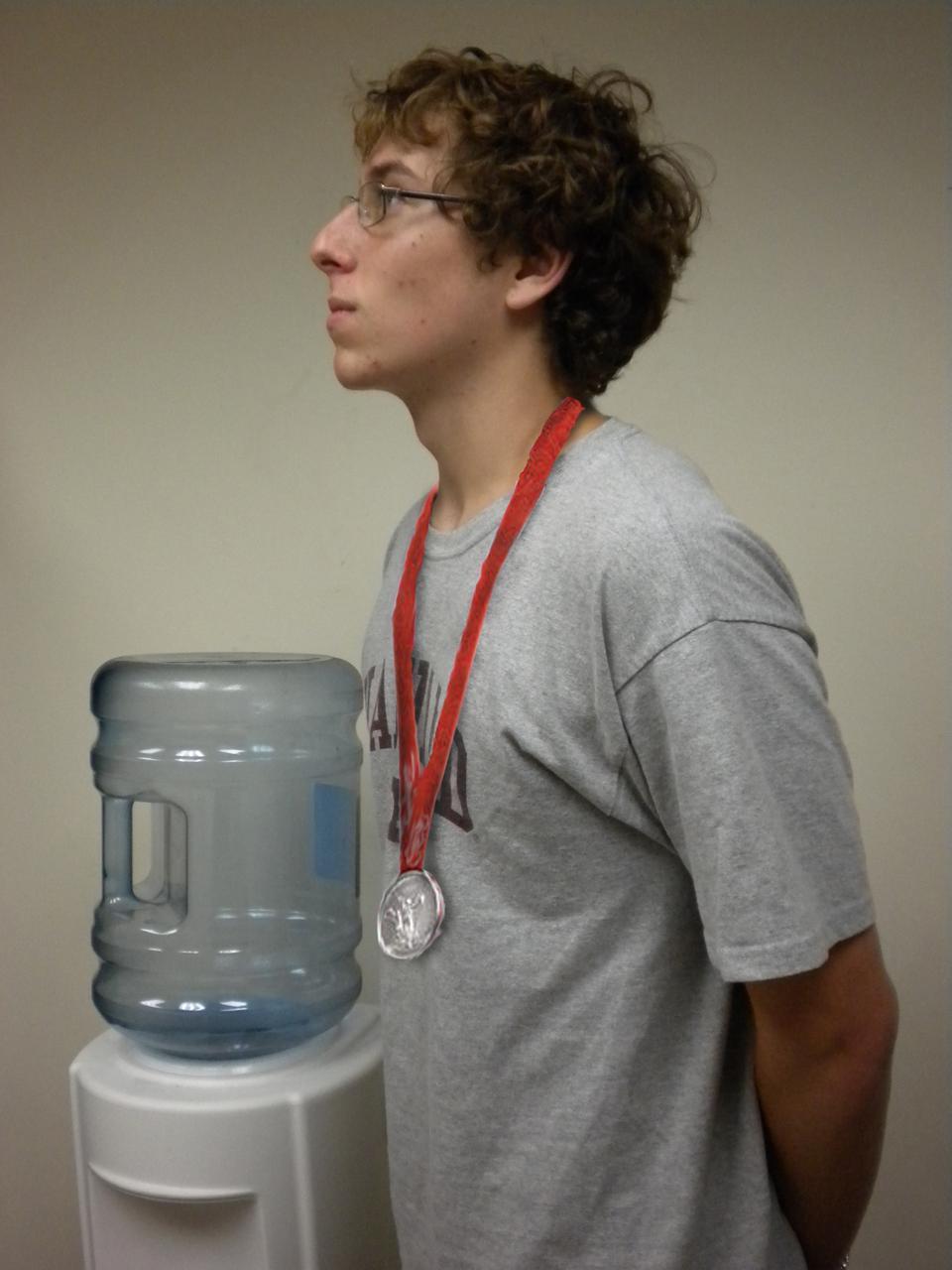 Solemnly I stand by the water cooler...