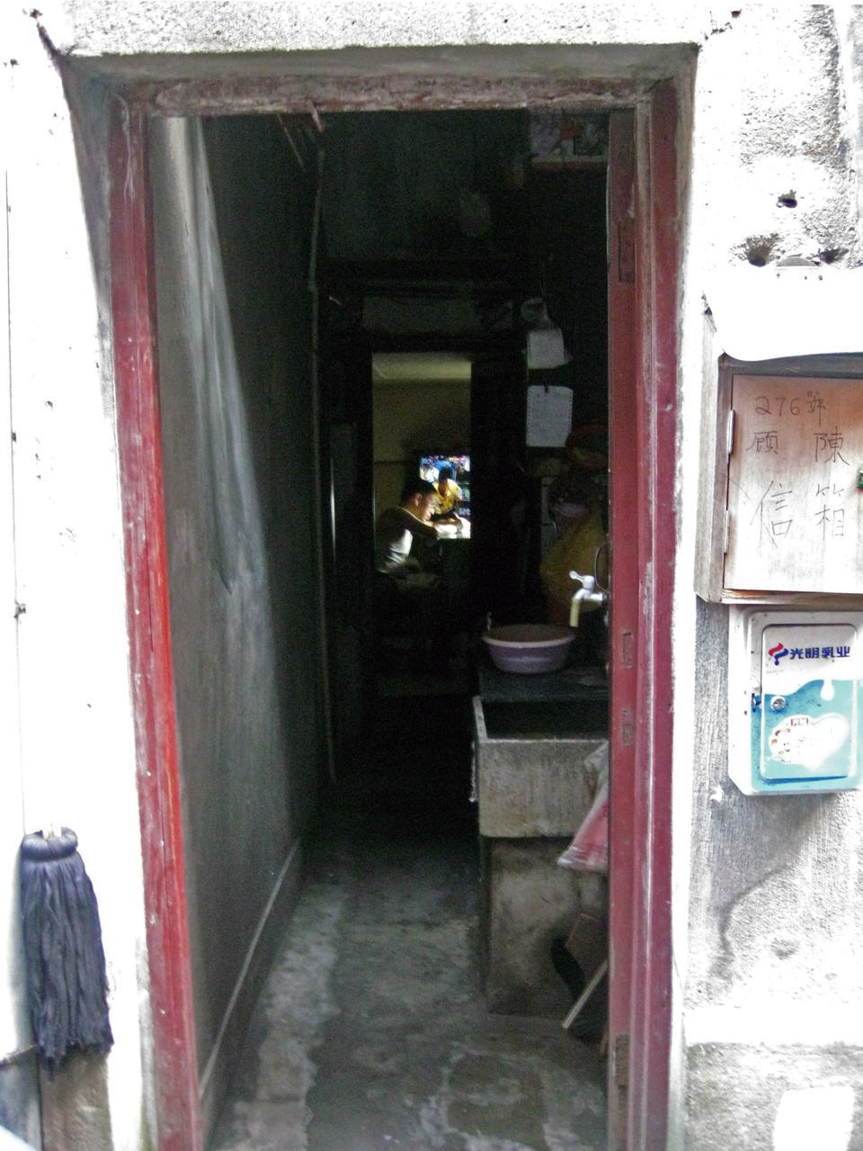 Inside an old Shanghai one-story apartment with peeling paint and rusted pipes, a man does work while watching a popular replay of the NBA final. The area around his home, Tianzi Fang, has preserved its antique charm despite its residents leasing spaces for restaurants, boutiques, and cafes that bring both local and tourist foot traffic.