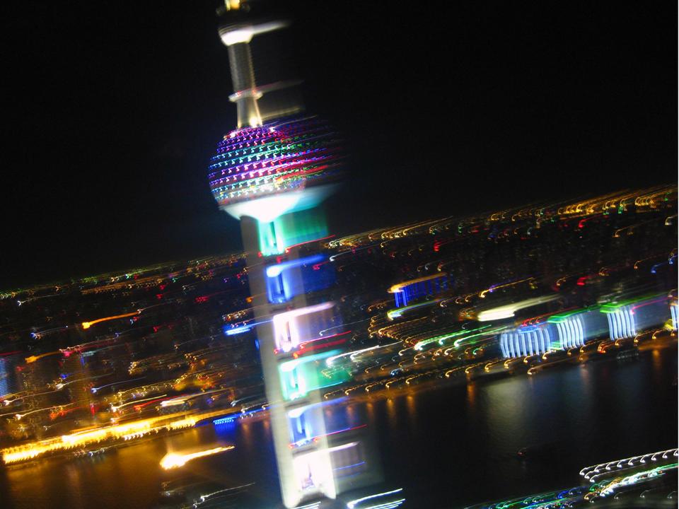 The dizzying view of Shanghai at night, featuring the Oriental Pearl Tower.