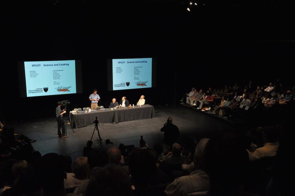 The instructors of Science of the Physical Universe 27: Science and Cooking present a lecture at the Loeb Drama Center. (CORRECTION: The caption incorrectly stated that the image depicted Lowell Lecture Hall. The caption has been fixed to reflect the error.)