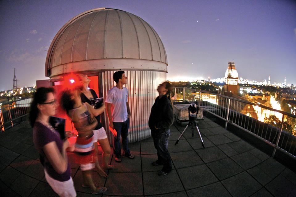 Several freshmen stargaze by the telescopes on the roof of the Science Center yesterday evening as Allyson Bieryla, Astronomy Lab and Telescope Manager, points out salient celestial objects. The telescopes and roof were opened to promote the General Education course SPU21: Stellar Measures of the Universe.