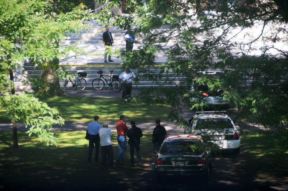 Police investigate the scene of a fatal shooting on the steps of Memorial Church on Saturday.