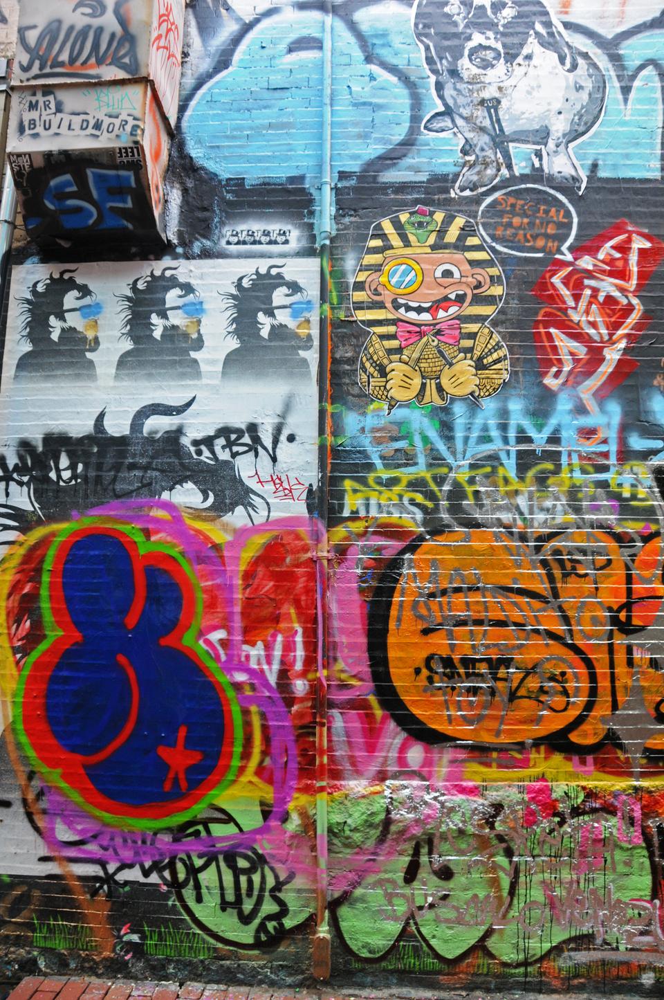 This is part of the 81-foot graffiti wall on Modica Way located in Central Square. The entirety of this wall is covered from top to bottom with stencils, posters, and other works as part of a public art project outside Central Kitchen.