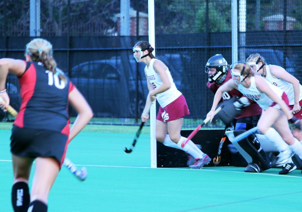 Sophomore goalie Cynthia Tassopoulos guards the net with the help of her fellow teammates as an onslaught of Huskies try to score a goal. Northeastern’s dominance resulted in an emphatic 4-0 win over the Crimson, sentencing Harvard to its fifth loss in a row. 