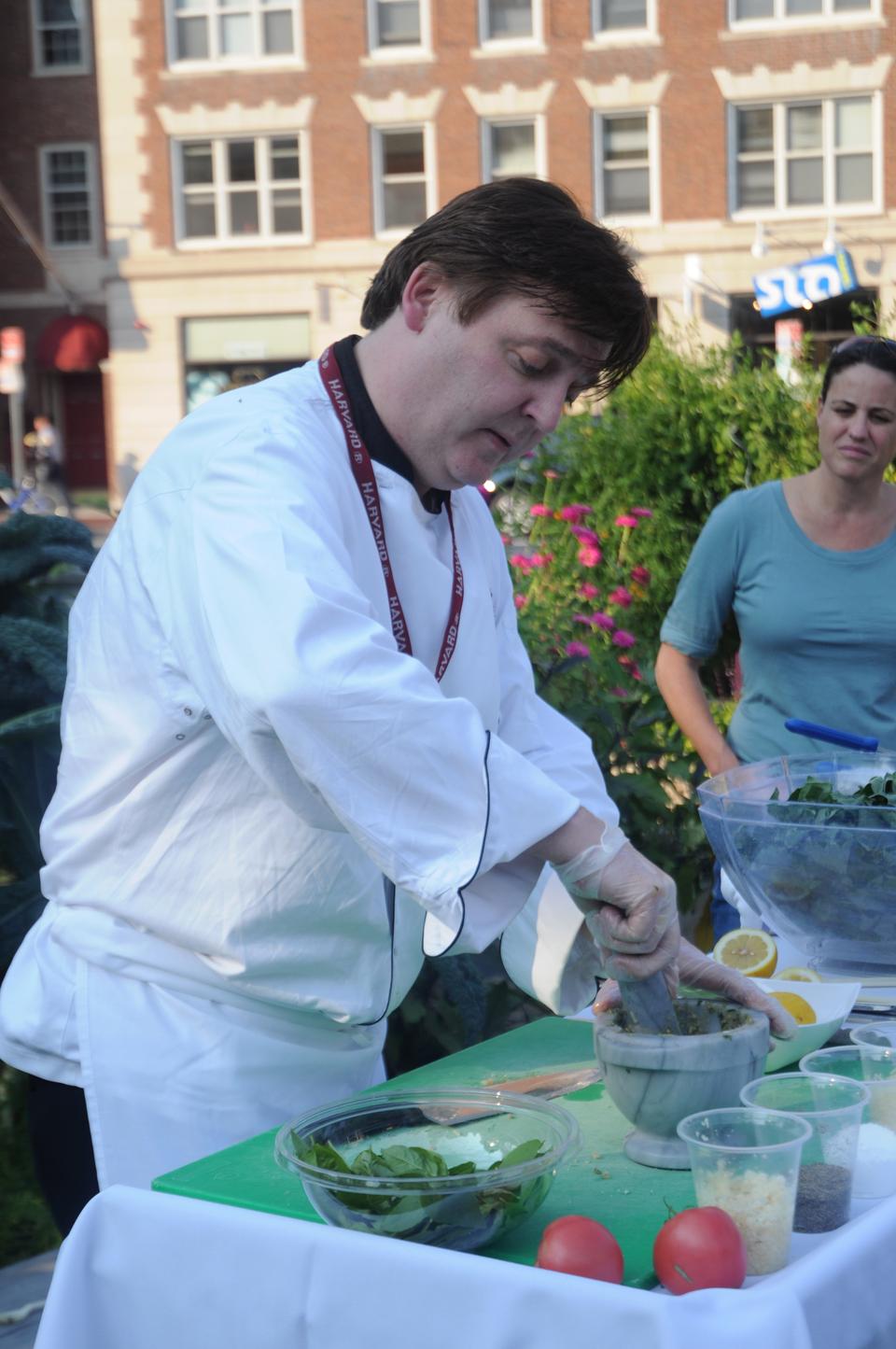 Martin Breslin, director for culinary operations at HUHDS, prepares fresh pesto and braised kale for an audience at the Harvard Community Garden yesterday. The main ingredients were harvested from the garden itself.