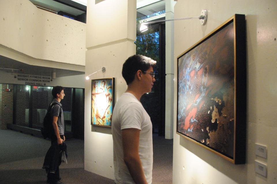 Maximilian C. Evans '13 and Carl Daher '13 stop to examine the original work of photographer C. E. Morse at the Mather Three Columns Galleria yesterday. Morse's exhibit opened yesterday and features photographs of paintings found in nature.