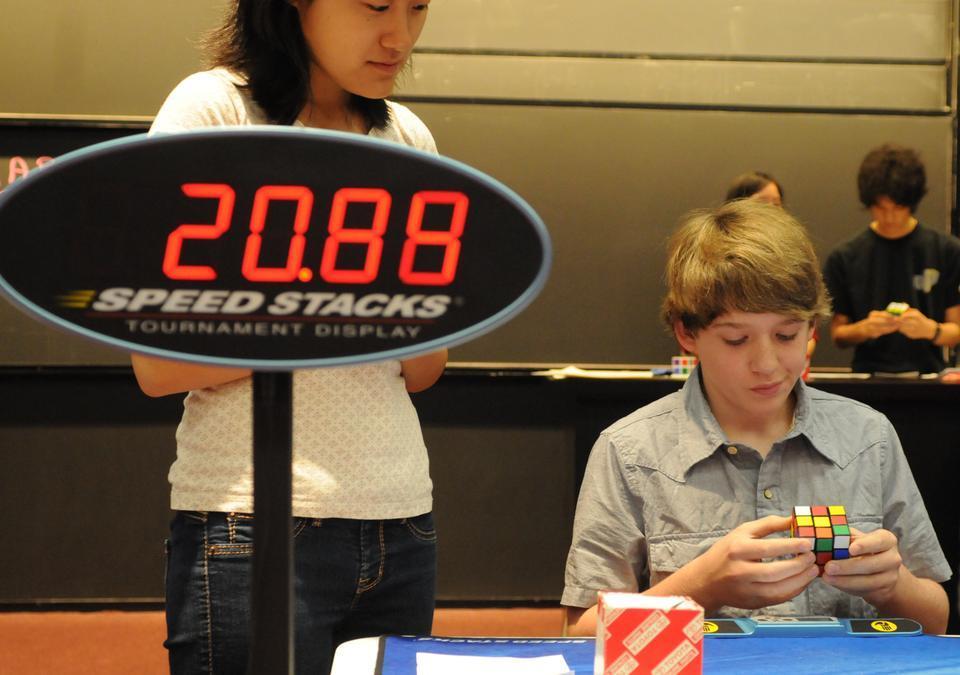 Will Nellis,a 12-year-old from Connecticut, inspects a 3x3 cube on Saturday at Harvard's Rubik's Cube Competition, organized by the Harvard College Cube Club.