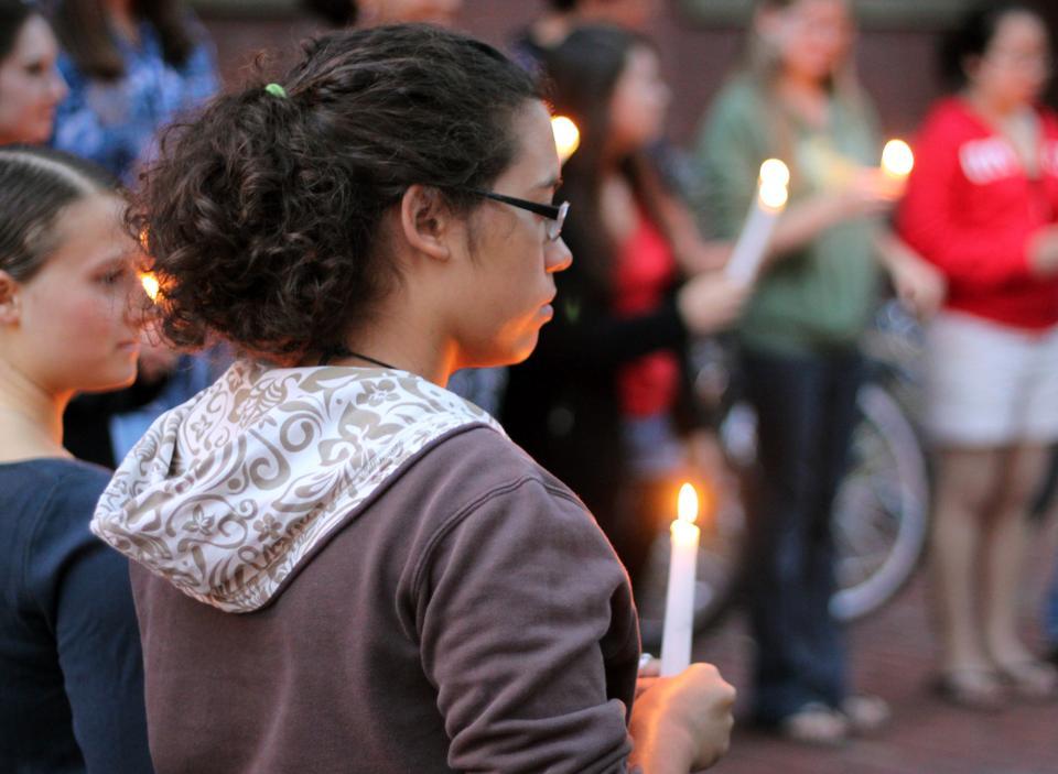 Students observe Indigenous Peoples' Day with a candlelight vigil outside Matthews. The event, held Monday night, celebrated the survival of Native American culture.