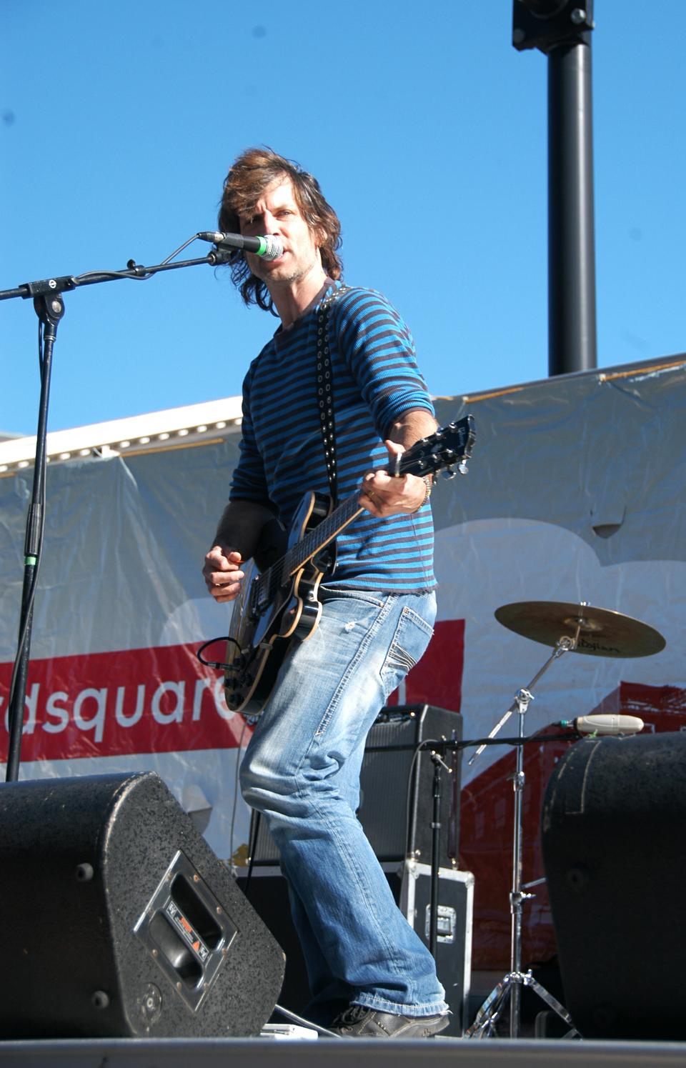 A rock band performs in front of crowds at the Oktoberfest celebration