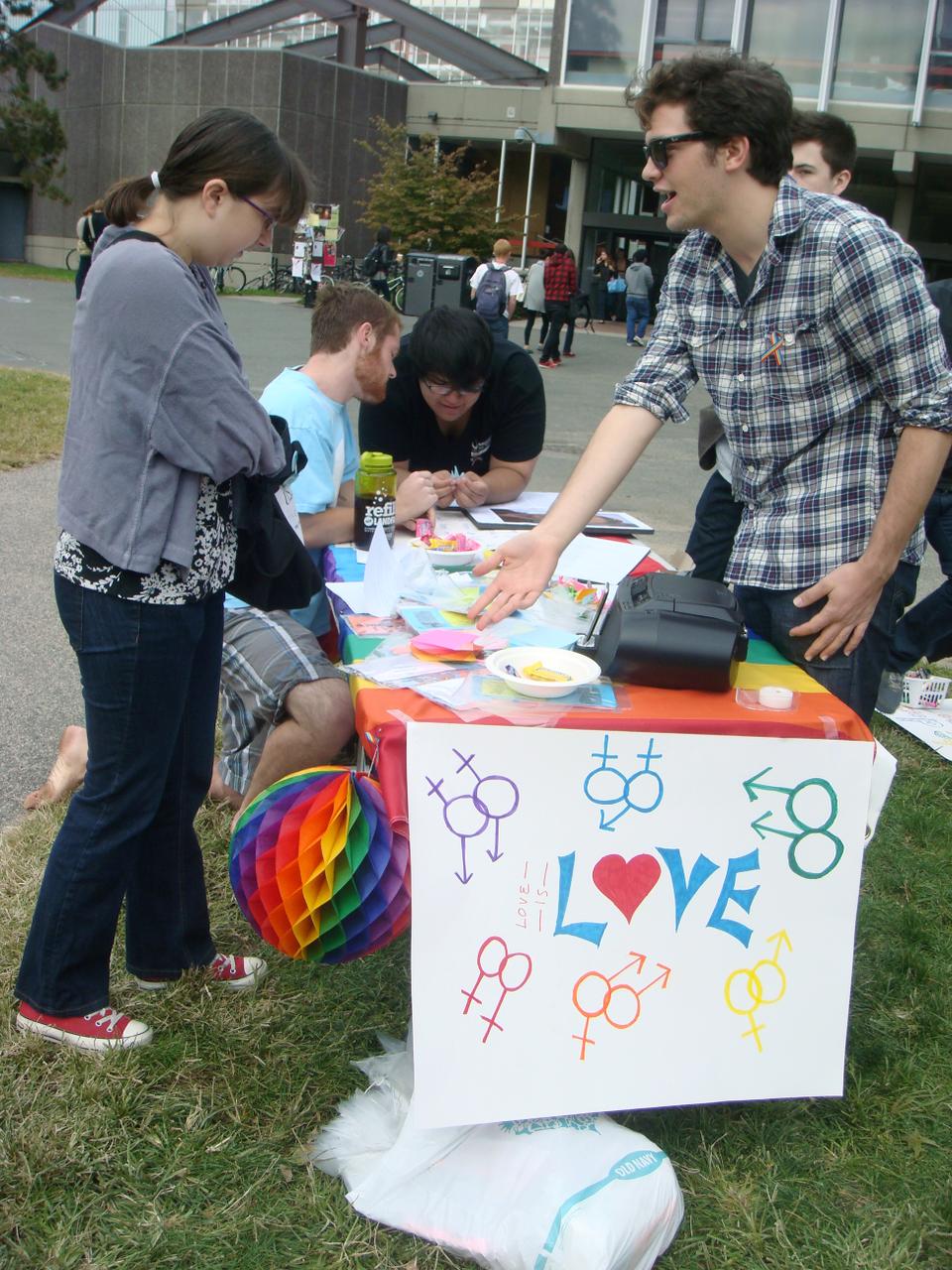 QSA member and Crimson editor Ryan Rossner shares the love with fellow students and allies on National Coming Out Day as “I’m Coming Out” blasted over the speakers.