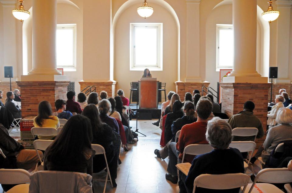 Author Meg Kearney, author of the PEN/L.L. Winship Award-winning “Home By Now” addresses the audience during a workshop entitled “Poetry of Love, Loss, and Healing” in the Boston Public Library reading room. 
