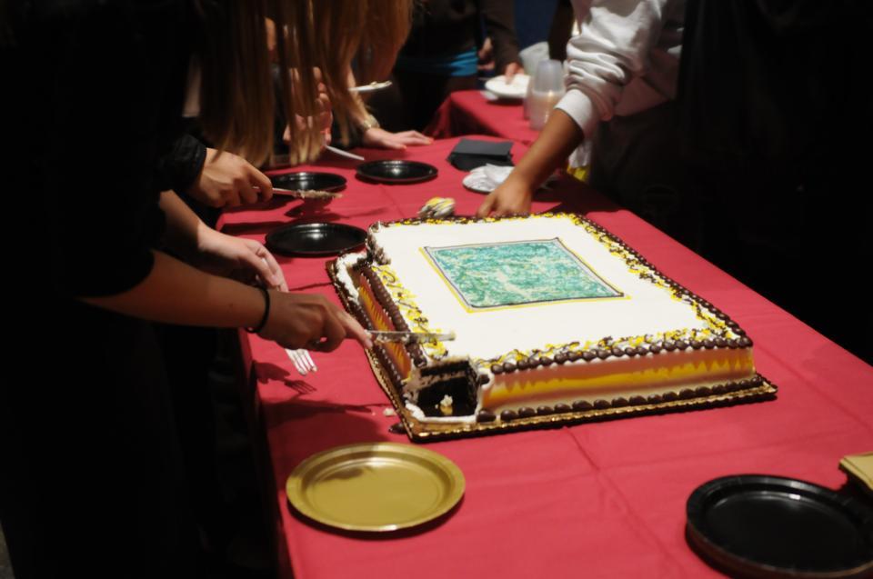 Cake was served following a welcoming speech to attendees.