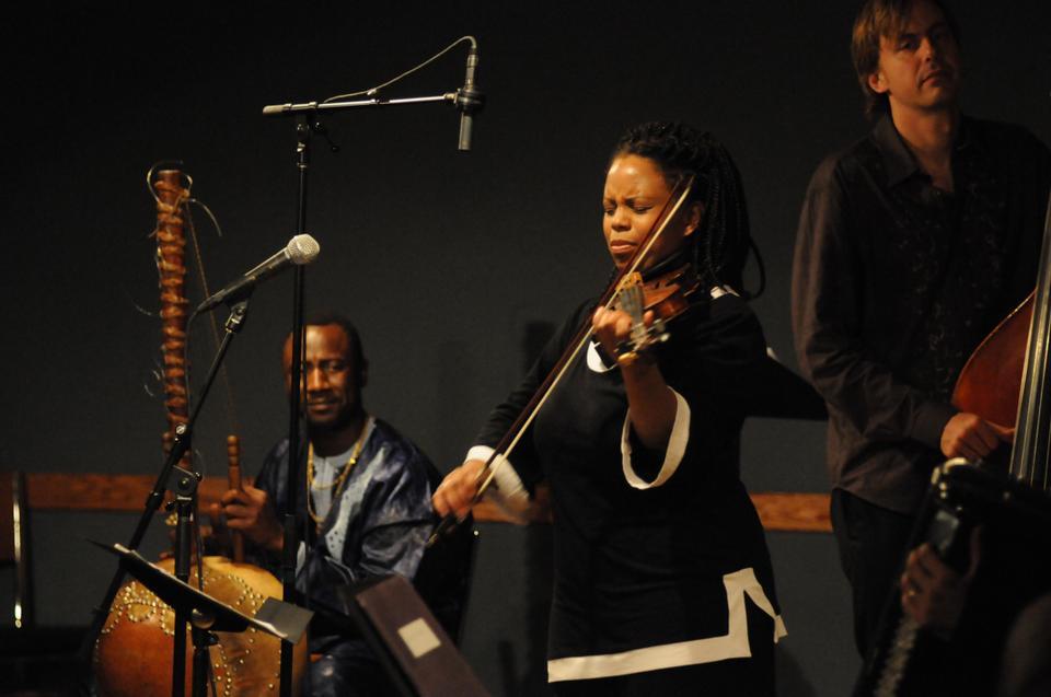 Regina Carter, jazz violinist and MacArthur fellow, performs Friday at The Charles Hotel: Regattabar.  Carter adds the accordion and the kora (the traditional West African harp) to her band to perform African folk tunes from Kenya, Senegal, and Mali.  Carter spent three years researching and collecting material for this project, "Reverse Thread," after winning the MacArthur Fellowship.  