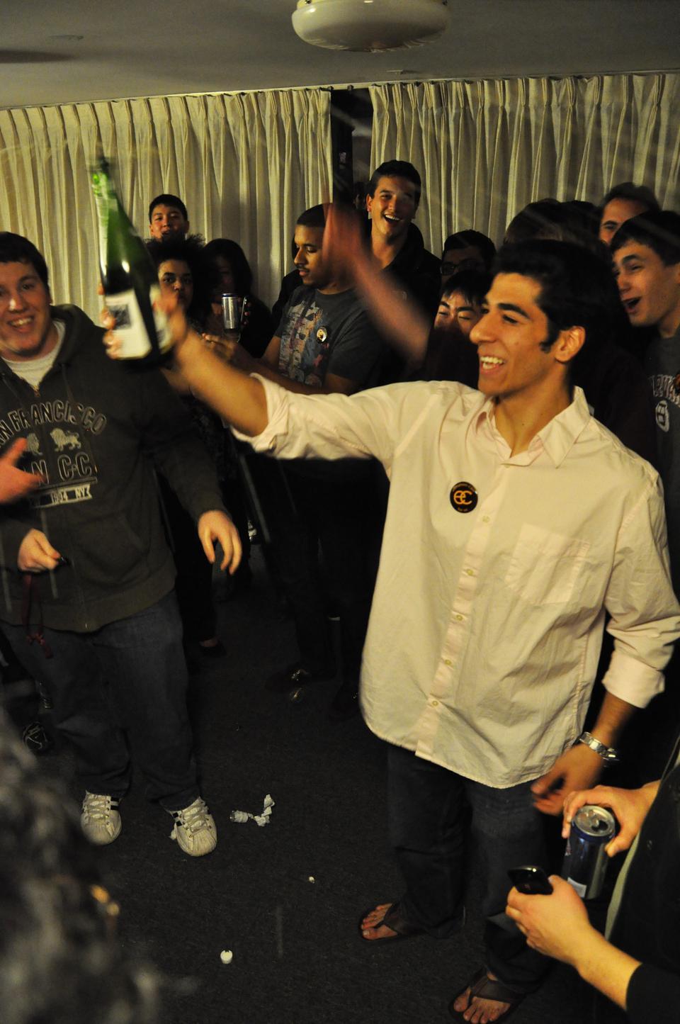 Senan Ebrahim ‘12 raises of bottle of apple cider to all the supporters of his campaign after learning that he won the election for president of the Undergraduate Council last night.