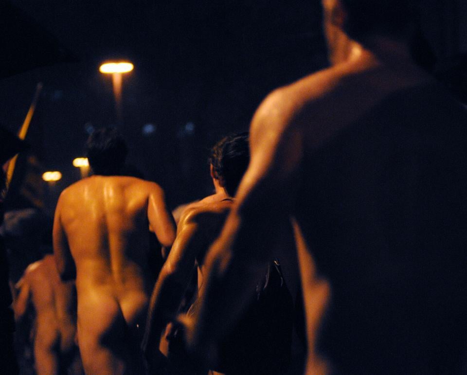 Harvard students celebrate the beginning of exam period with a naked run through the rain.